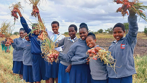Young girls with vegetables from BEADS for Education