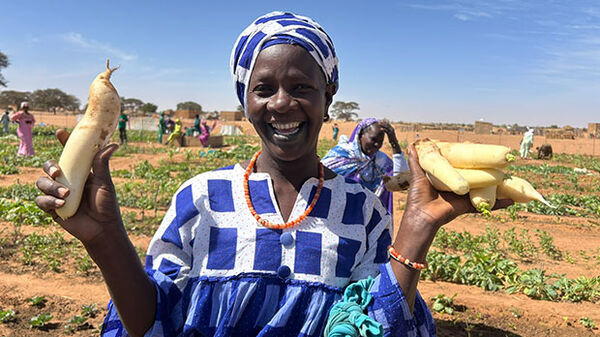 woman-wearing blue scarf-holding-vegetables