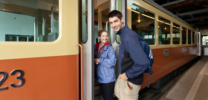 Smiling couple boarding train, Switzerland