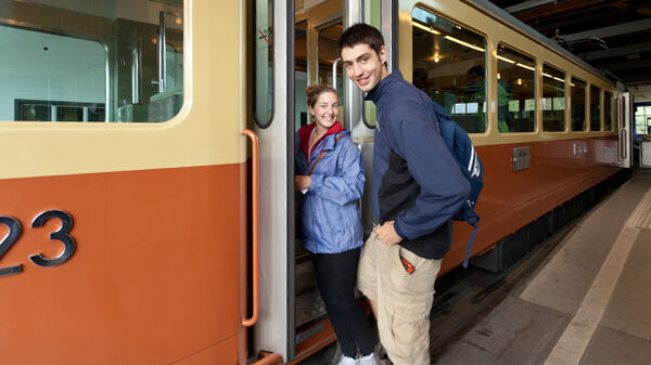 Smiling couple boarding train, Switzerland