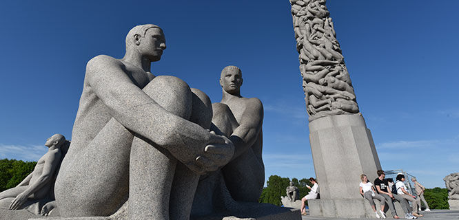 statues of two men sitting at frogner park in oslo