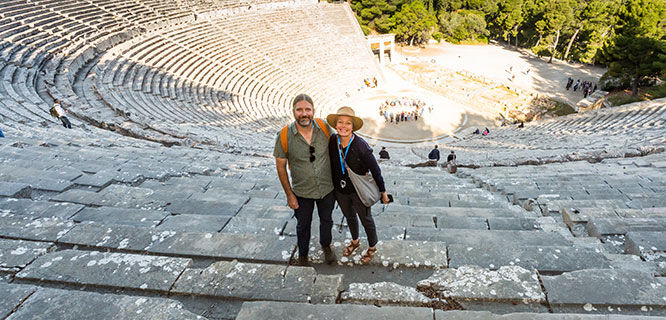 amn and woman standing in an ancient ampitheater