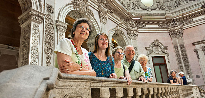 group of people standing on balcony at porto stock exchange building