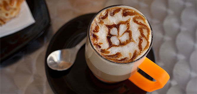 cup of coffee with design in foam