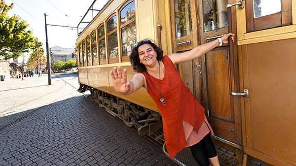 Lady in red dress and trolley, Lisbon, Portugal