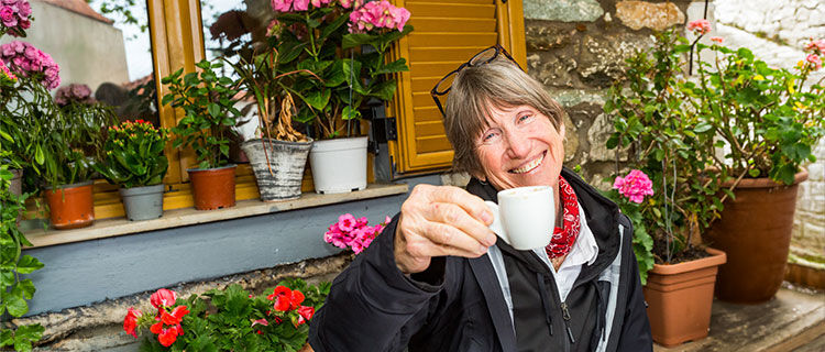 Lady toasting with coffee cup, Greece