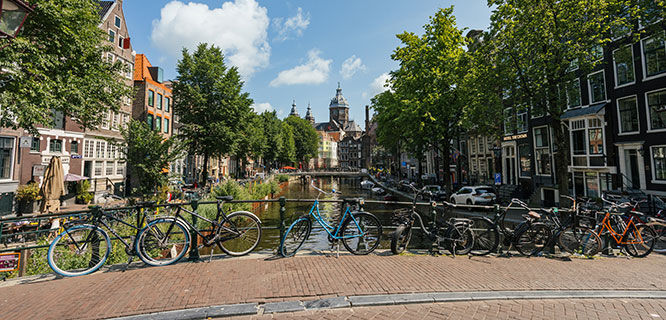 amsterdam canal view from bridge with bikes
