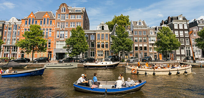 Canal boats in Amsterdam, with gabeled buildings in the background
