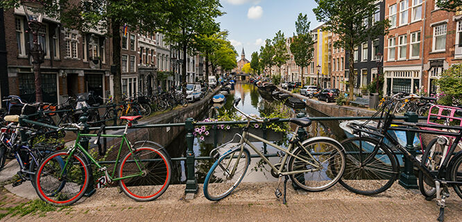 bicycles against the railing of a canal bridge in Amsterdam's Jordaan neighborhood