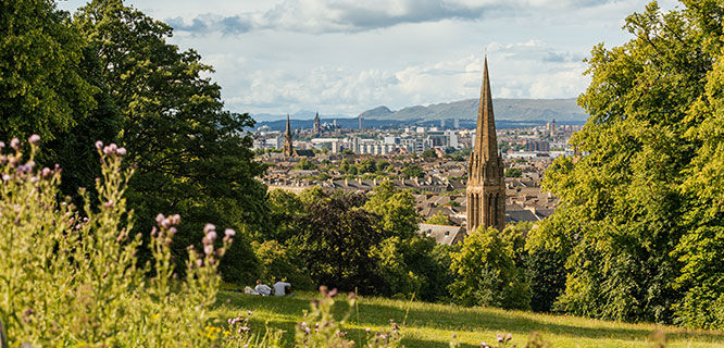 skyline view of glasgow from grassy hill