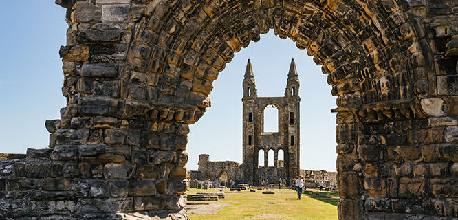 cathedral ruins viewed through a stone arch