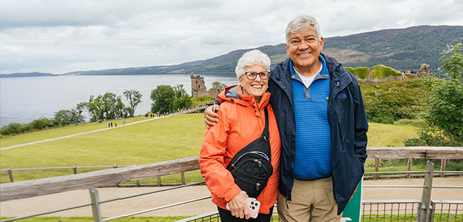 man and woman in front of a lake