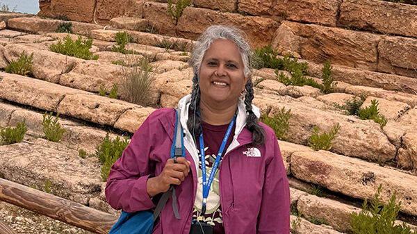 woman standing with stone steps in background