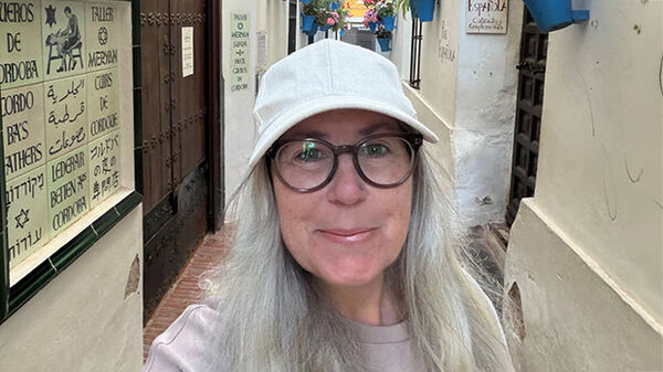 woman wearing white ball cap