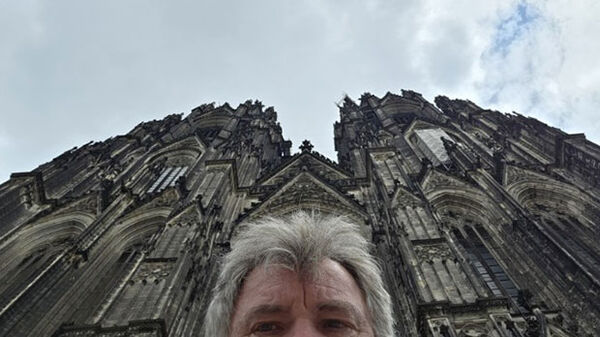 top of man's head with cathedral in background