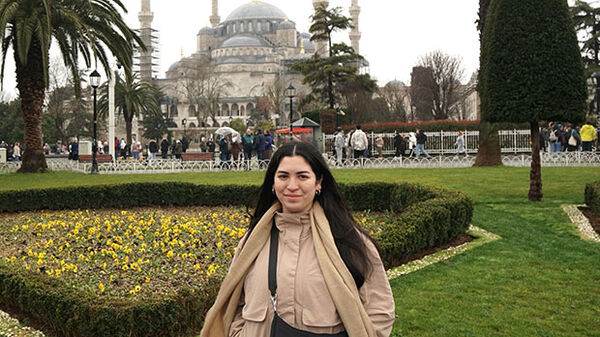 woman standing in front of mosque