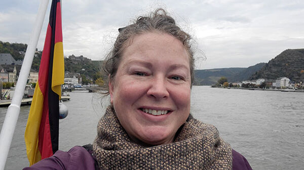 head shot of woman with lake in the background