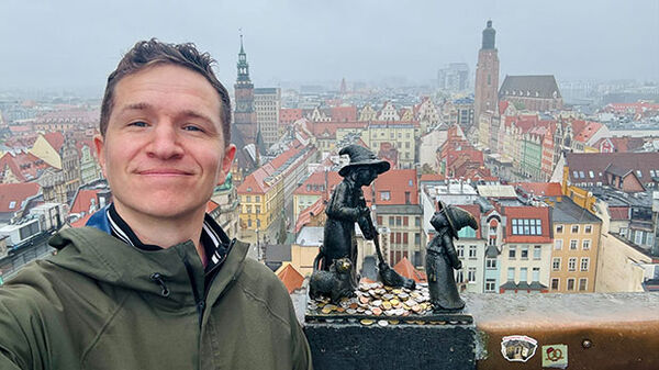 man with foggy city scape in background