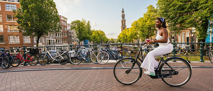 Lady riding a bike in Amsterdam