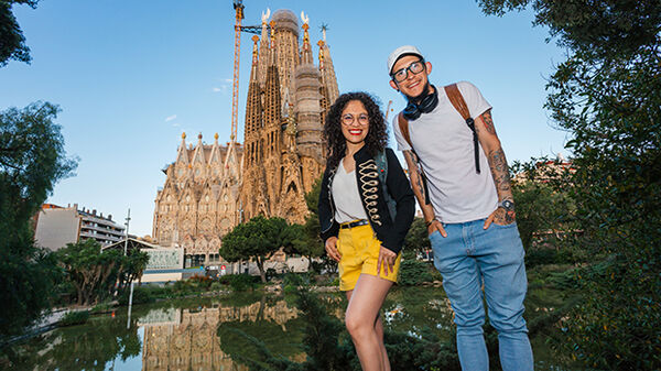 Young woman and man outside Sagrada Familia, Barcelona, Spain
