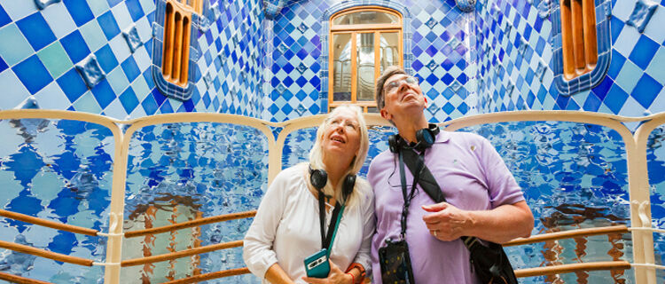 Woman and man tour members inside Casa Batlló, Barcelona, Spain