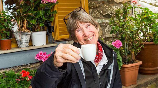 Lady toasting with coffee cup, Nafplio, Greece