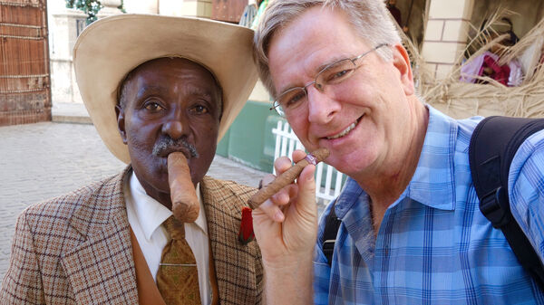 two men smoking cigars