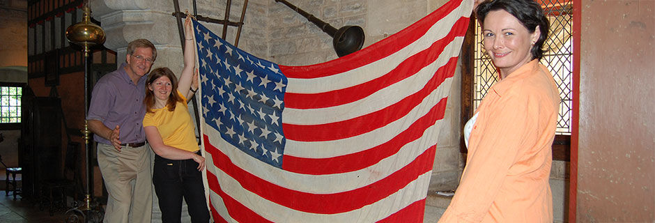 Rick with two girls holding WWII US flag, Beaune, France