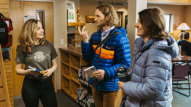 a salesperson talking to two customers
