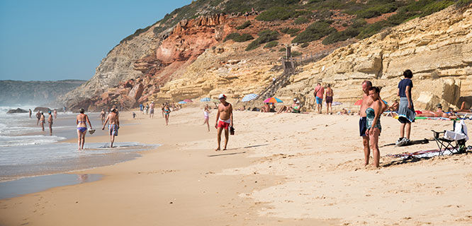 people on a beach in portugal's algarve