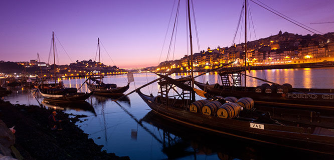 Boats on river with purple dusk, Porto, Portugal