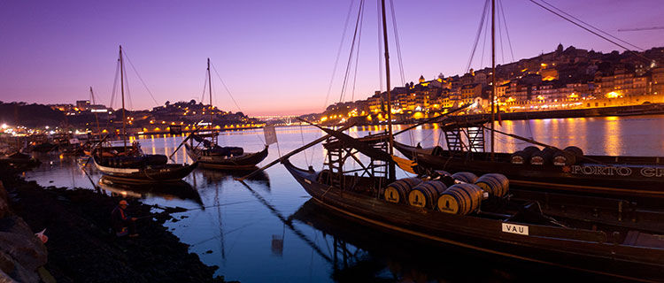 Boats on river with purple dusk, Porto, Portugal