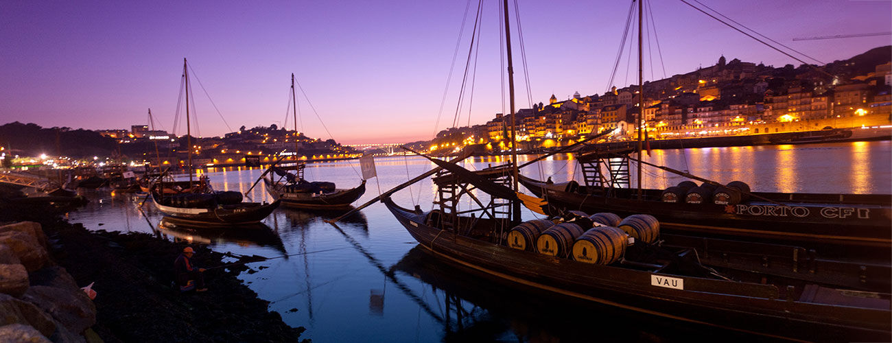 Boats on river with purple dusk, Porto, Portugal