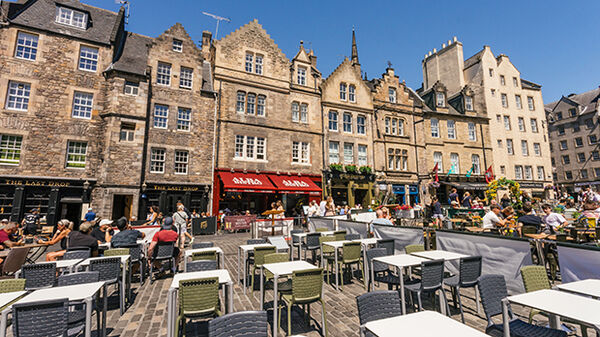 Outside tables and diners, Grassmarket, Edinburgh, Scotland