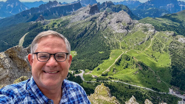 Selfie of Cameron Hewitt above mountain valley, Switzerland