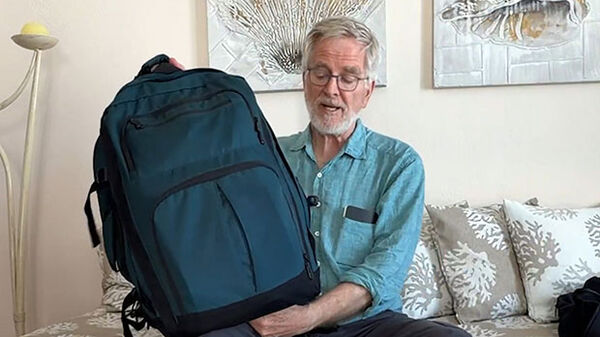 Rick holding Convertible Carry-On in hotel room, Greece