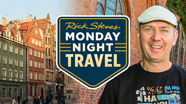 colorful buildings on left man in hat on right