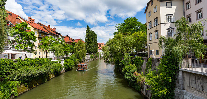 turquoise river with buildings and greenery