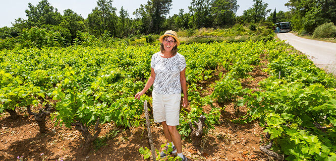 lady standing in vineyard