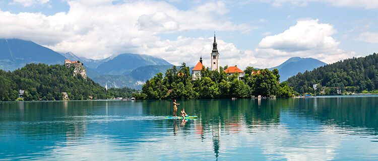 Island and paddleboarders, Lake Bled, Slovenia