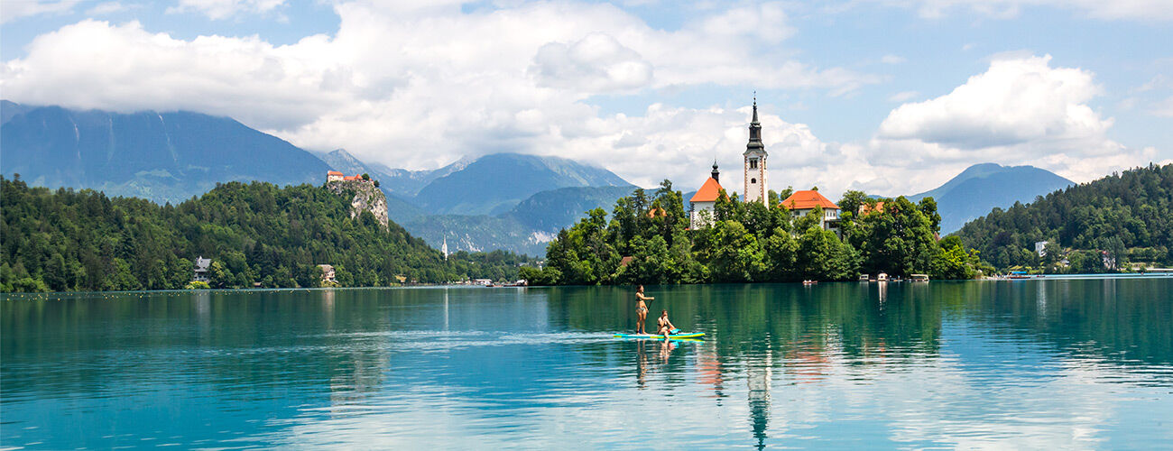 Island and paddleboarders, Lake Bled, Slovenia