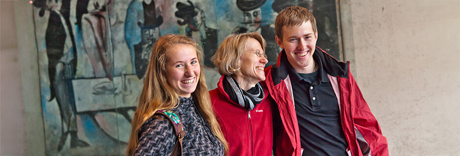 Smiling trio at museum, Berlin, Germany