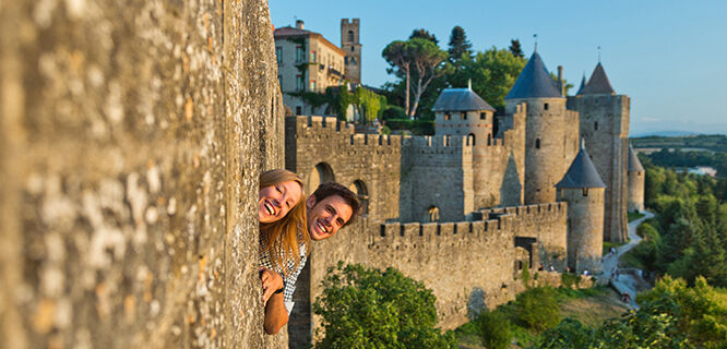 couple-peeking out of a castle window
